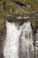 An adventurous kayak experience is paddling over a waterfall.