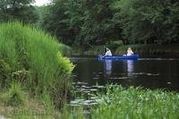 A couple enjoy a peaceful canoe on the Mersey River of Kejimkujik Park in Nova Scotia, Canada.
