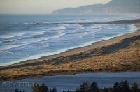 The long stretches of sandy beach along the breakers near Kincheloe Point in Oregon are popular for crabbing and fishing.
