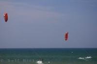 Two kitesurfers test their skills on a magnificent day at the Oliva Nova Beach in Valencia, Spain in Europe.