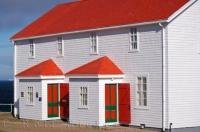 The red, green and white building which was home to lightkeepers, is now deemed as a historic site in Southern Labrador, Canada.