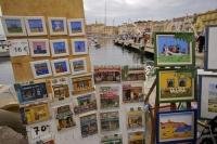 The local talent of the artists of Saint Tropez in Provence, France can be seen along the Quai Suffren in the Old Town where many visitors come to enjoy the beautiful scenery.