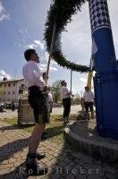 The finishing touches of greenery are added to the Maibaum in Putzbrunn, Germany, near Munich.