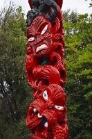 The intricate details of the carving on a totem which depicts Maori legends and culture.