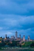 The historic medieval architecture and towers of San Gimignano seen from a distance at dusk, a UNESCO World Heritage Site in the province of Siena, Tuscany, Italy.