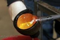 The super hot, molten glass is shaped with a special tool at the Lincoln City Glass Center in Oregon, USA.