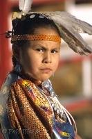 A cute Native Indian Girl adorned in her customary dress at a pow wow in Alberta, Canada.