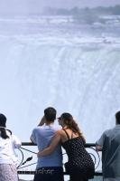 Niagara Falls in Ontario, Canada brings in thousands of tourists annually such as this romantic couple overlooking the Horseshoe Falls.