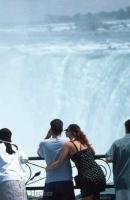 A romantic couple looking over the Niagara Falls in Ontario