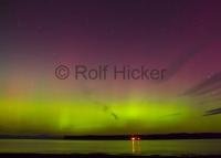 The contrasting colours of the Northern Lights seen from Port McNeill at the North end of Vancouver Island BC