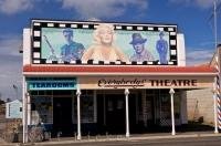 The old Opunake movie theater with a painted wall mural, along the Surf Highway in the Taranaki region of New Zealand.
