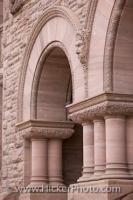 Details of the facade of the Ontario Legislative Building in Toronto includes faces carved into the stone wall, columns and intricate stonework set all around the arches. The Legislative Building is a fine example of Richardsonian Romanesque architecture.
