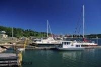 House and sail boats tied up in a harbor on Manitoulin Island, Lake Huron in Ontario, Canada.