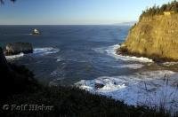 The sun begins to set along the rocky Oregon  Coastline at Cape Meares State Park, USA.
