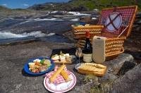 Enjoying a meal out of a picnic hamper surrounded by the tranquility, the Mealy Mountains and a waterfall is what makes up some of the region of Southern Labrador in Newfoundland Labrador.