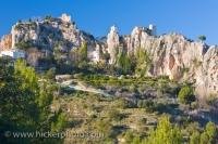 The picturesque village of Guadalest in the Province of Alicante, Spain is a popular tourist destination and attraction which is perched on the edge of a granite mountain with stupendous views across the river valley below.