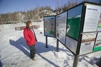 A tourist checks out the information about a Alaska Pipeline viewpoint near Fairbanks, Alaska, USA.
