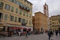 A typical cafe and street scene in Place du Palais where tourists love to explore in the Old Town of Nice, a City in the Cote d'Azur in Provence, France.