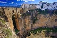 The Puente Nuevo, meaning the New Bridge in Spanish, spans the El Tajo Gorge and the Rio Guadalevin river within the town of Ronda in the gorgeous Costa del Sol region of Malaga. This is located in Andalusia in Spain.