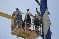 A few of the Putzbrunn men add a variety of Company signs to the Maibaum in Southern Bavaria, Germany.