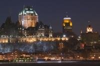 At night in Quebec City the lights are illuminated emitting a glow along the city skyline.