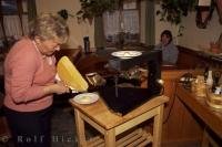 A lady prepares a traditional Raclette, a favorite meal that originated in Switzerland.