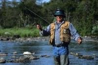 A visitor staying at the world class Tuckamore Lodge in Newfoundland, Canada enjoys fly fishing in nearby Trout River.