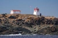 As you travel along the rocky coastline of St. Anthony in Newfoundland, Canada the lighthouse prominently stands out on top of the hillside.