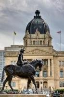 An equestrian statue of Queen Elizabeth II stands in the Queen Elizabeth II Gardens backdropped by the Saskatchewan Legislative Building in the City of Regina, Province of Saskatchewan in Canada.