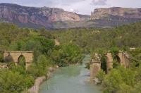 This serene section of the Gallego River in Huesca, Aragon in Spain with the ruined bridge on either bank, can become more turbulent in the higher terrain.