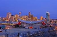 The Calgary Saddledome begins to light up at sunrise as the city comes to life, as can be seen here in this picture of the city of Calgary in Alberta. The Saddledome is one of the most recognizable structures in this Cowboy city.