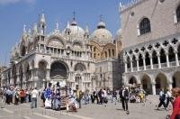 Saint Marks Basilica and the Doges Palace in the busy Saint Marks Square in Venice, Italy in Europe.