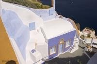 A great vacation photo of a colorful greek house in Oia on Santorini Island in Greece.