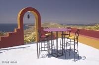 A Restaurant in Santorini has an outdoor patio area for diners to take in the wonderful view under the Mediterranean sun.