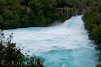 Tourists stand atop the lookout points for a scenic view of the Huka Falls as the Waikato River near Taupo on the North Island of New Zealand squeezes through a narrow passage.