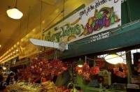 A fresh produce store displaying chilli pepper wreaths at the Public Market Center in downtown Seattle.