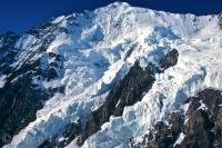 Snow covered mountain peaks glistening in the sunlight on a beautiful clear day, are a common sight in Kluane National Park in the Yukon Territory.