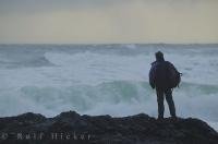 A tourist is watching a massive storm on the west coast of Vancouver Island in British Colmbia Canada