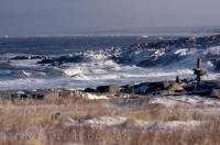 The Hudson Bay coastline begins to form ice as winter approaches in Churchill, Manitoba, but the stormy water is still able to crash against the rugged rocks.
