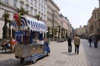 A man selling Gelati is one of the many street vendors that travel throughout Graben Square in the downtown core of Vienna, Austria.