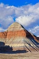 Various layers of materials, some stained by chemical compounds, are clearly seen on the Tepees, a collection of formations in Petrified Forest National Park in Arizona, USA.