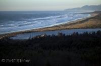 A view north across the breaker along the coastline apposite Tillamook Bay along the Oregon Coast, USA.