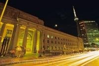 The lights at night in downtown Toronto, Ontario give the impression that the roadways and the train station are made of gold.