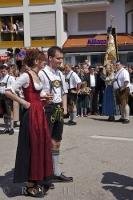 A woman wears a traditional Bavarian dirndl while the man wears lederhose during the Maibaumfest in Putzbrunn.