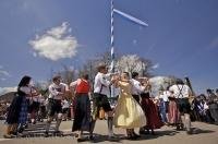 Dancers perform at the base of the traditional Maibaum during a celebration dance in Putzbrunn, Bavaria, Germany.