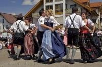 A group of people dance near the Maibaum during the traditional Maibaumfest in Putzbrunn, Germany.