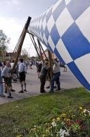 The Maibaum is painted in traditional blue and white colors for the Maibaumfest held in Putzbrunn, Germany.
