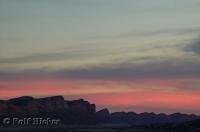 Colours of yellow and pink stream across the clouds at sunset in Utah, USA.