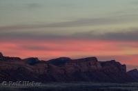 Stunning colours of pink glow above rock formations during sun set in Utah, USA.