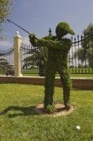 A manicured statue is teeing off outside the Oliva Nova Golf Course in Valencia, Spain in Europe.